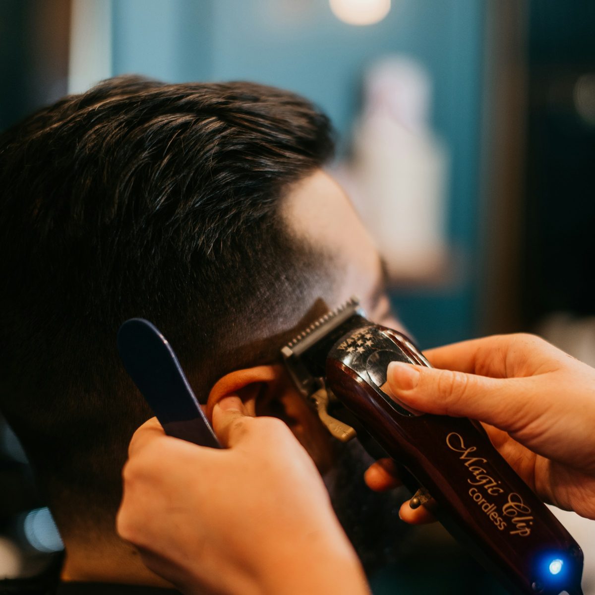 Friseur schneidet Haare mit dem Haarschneider